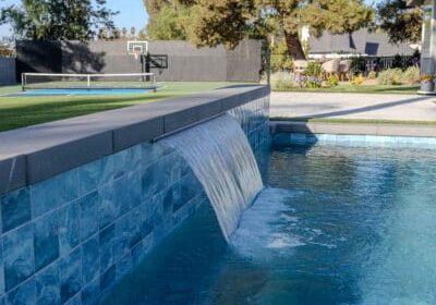 Beautiful backyard remodel with new pool water feature, sports court & outdoor dining area for Poway Residential Landscape Design & Build Renovation Project by Greenway Landscape Design & Build